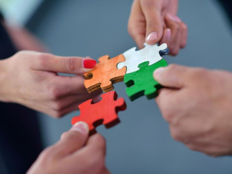 Hände Puzzleteile bunt