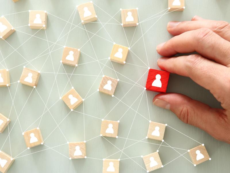 Netzwerk kleine Holzfiguren mit Faden vernetzt